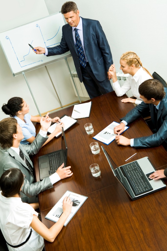 Above angle of business people listening to confident man during seminar Note to inspector: the image is pre-Sept 1 2009